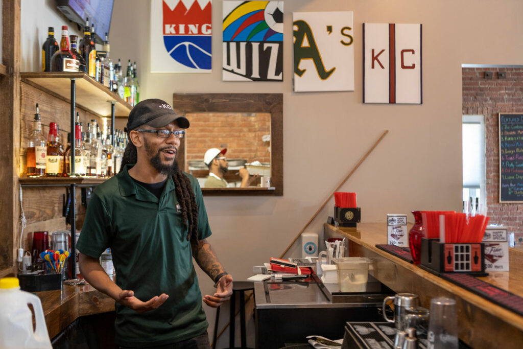 Small business owner Alan Kneeland works at the bar